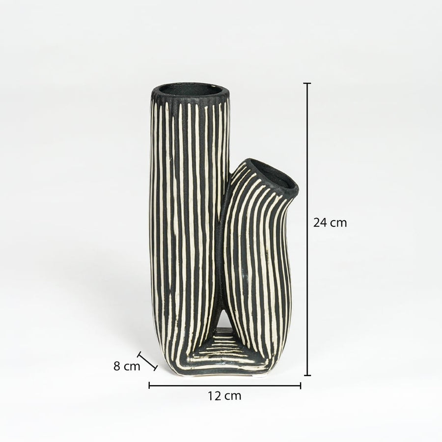 Black and white striped ceramic vase measuring 24 cm height 12 cm width and 8 cm depth ideal for modern decor styling.