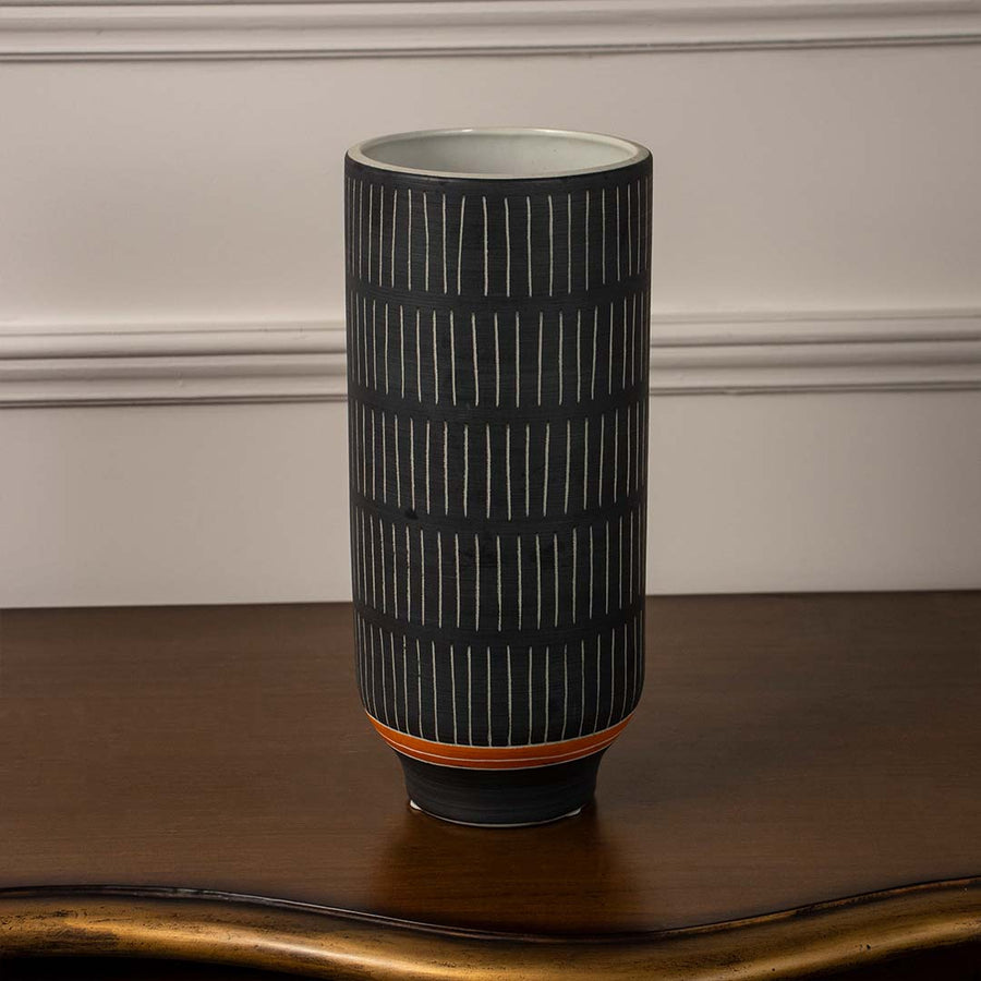 Black ribbed ceramic decorative vase displayed on white background offering modern minimalist accent for shelf or console decor.