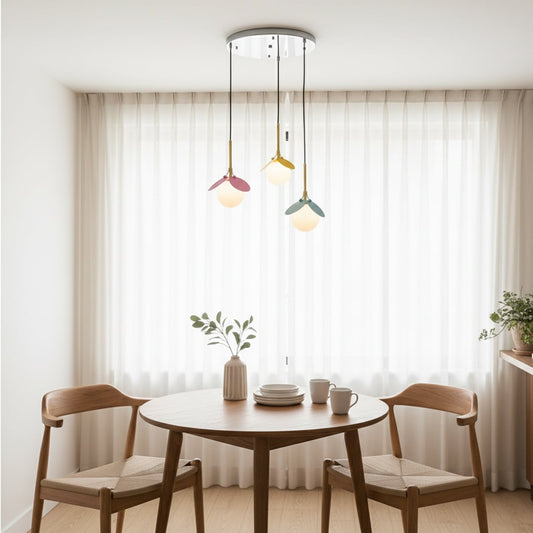 Soft ambient lighting with three playful pendant lights in pastel shades hanging beautifully to create a warm and modern decor setting.