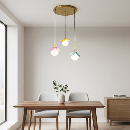 Pastel pink yellow and blue pendant lights hanging in a modern room adding a playful decorative touch with a soft contemporary look.