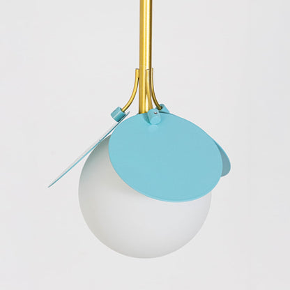 Closeup image of modern pendant light with frosted glass globe and blue metal petal accents shown light off on a clean white background.