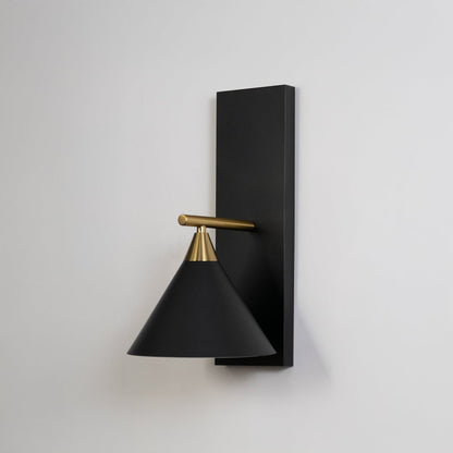 Contemporary black triangular shade wall light fixture with brass gold arm turned off on minimalist white background display.
