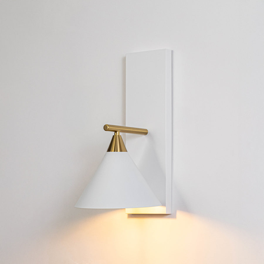 Minimal wall light in gold metal finish with cone shade for bedroom or living room ambient lighting decor white background.
