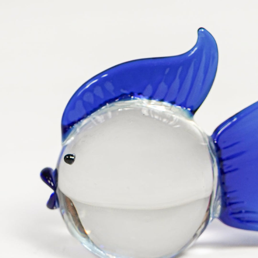 Close view of blue and white glass fish figurine featuring vibrant fins and smooth polished finish.