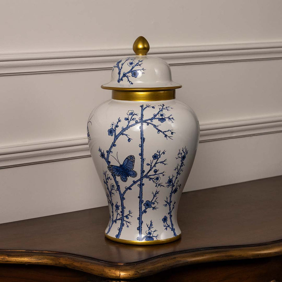 Handcrafted ceramic decor jar with blue floral pattern and golden top perfect for modern classic home interiors.