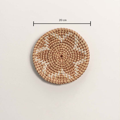 Small round woven wall basket measuring 20 cm in diameter featuring a brown spiral pattern and white stitches on a white background.