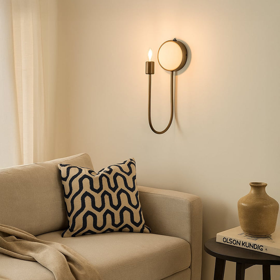 Designer metal and marble wall lamp adding sophisticated glow with curved silhouette ideal for hallways bedrooms or living room decor.