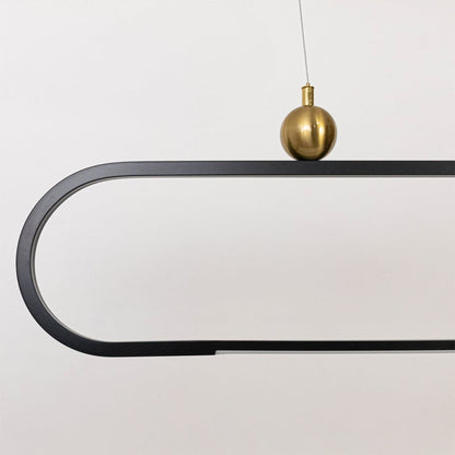 Closeup view of the modern chandelier highlighting its smooth metal frame and elegant gold spheres for a refined minimal look.