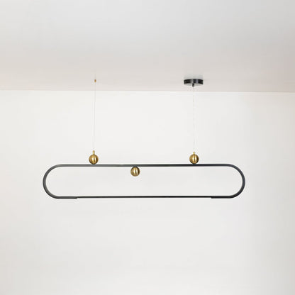 Chandelier shown on a plain white background with lights off highlighting its slim oval frame and gold decorative spheres.