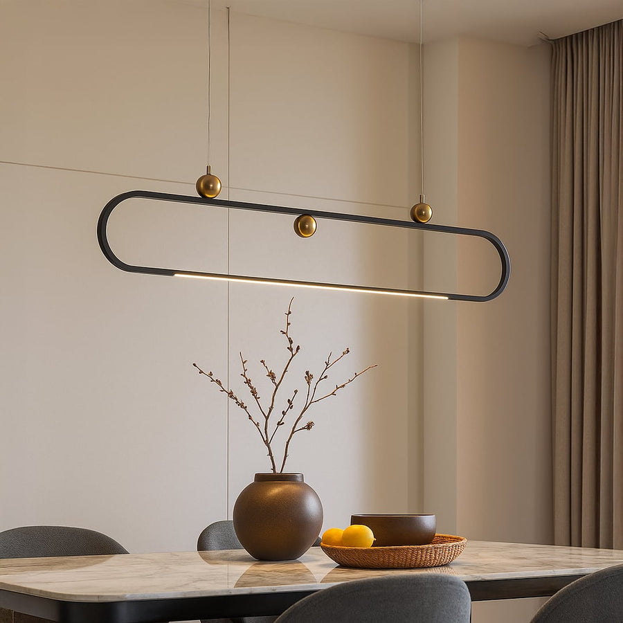 Modern chandelier displayed in a bright room showing its sleek oval frame and gold accents creating a stylish contemporary vibe.