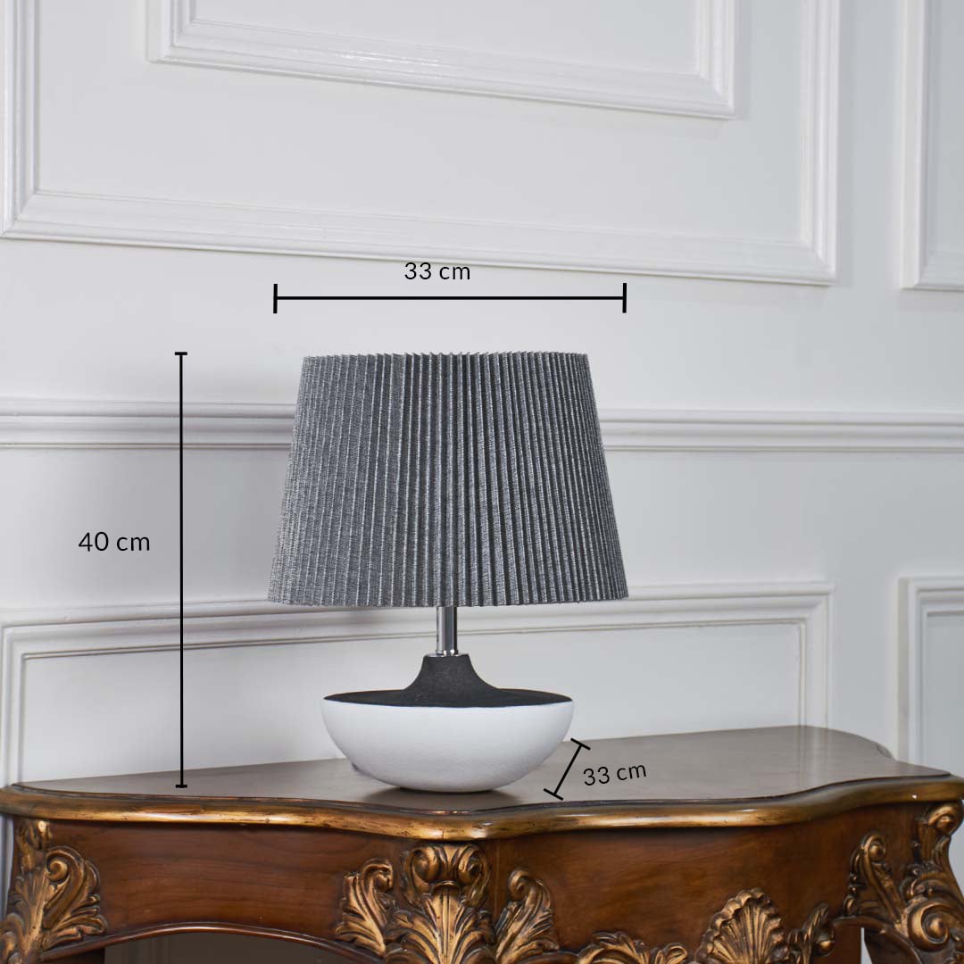 Black and white ceramic table lamp shown with 40 cm height and 33 cm shade width and 33 cm base width on a wooden console for accurate size reference.