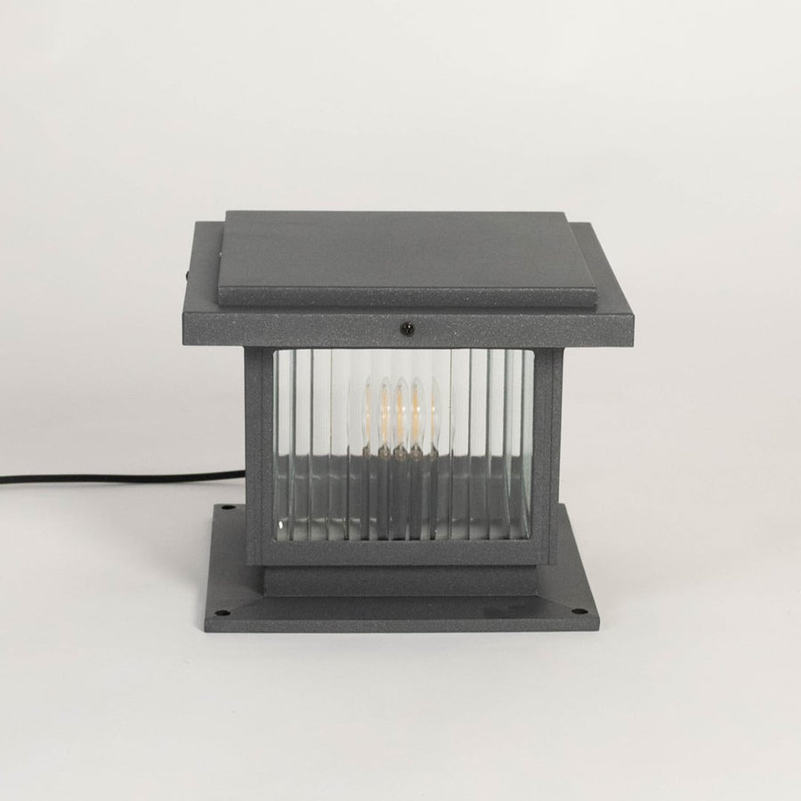 Modern black outdoor gate light with ribbed glass panels for stylish exterior decor use.
