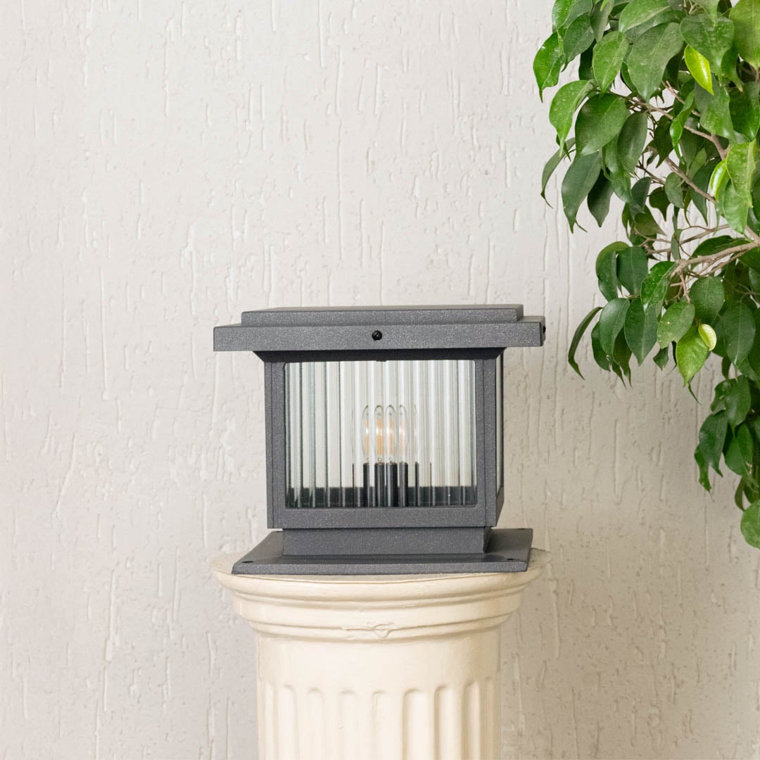 Modern black outdoor gate light with ribbed glass panels for stylish exterior decor use.