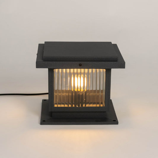 Black outdoor gate light with warm glowing bulb for elegant modern exterior decor styling use.