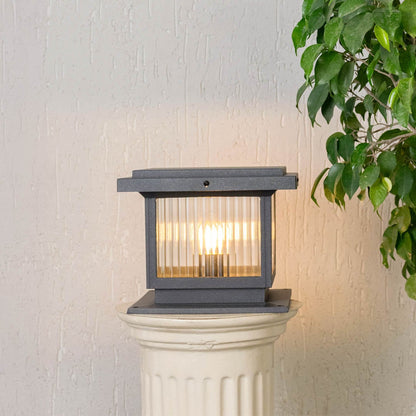 Black metal outdoor gate light with glowing bulb for stylish exterior decor styling use.