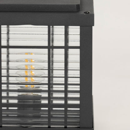 High quality frosted glass panel closeup of outdoor black pillar lamp crafted with metal frame for modern exterior lighting.