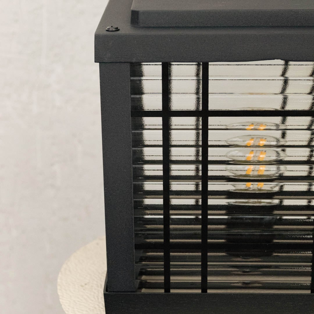 Outdoor black pillar lamp with frosted horizontal glass and sturdy base designed for patio balcony and garden decor.