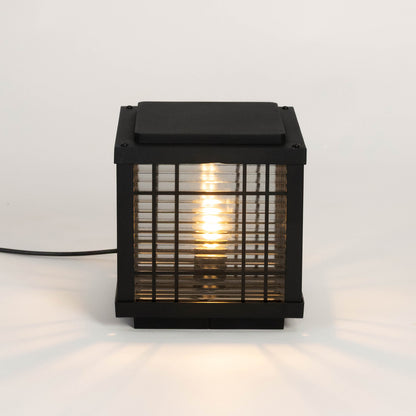 Black outdoor gate light with warm glowing bulb for elegant modern exterior decor styling use.