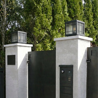 Modern black outdoor gate lights styled on entrance pillars for elegant exterior decor ambiance.
