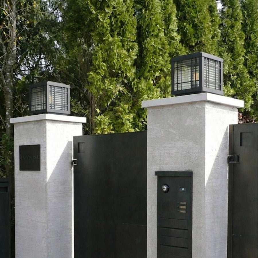 Modern black outdoor gate lights styled on entrance pillars for elegant exterior decor ambiance.