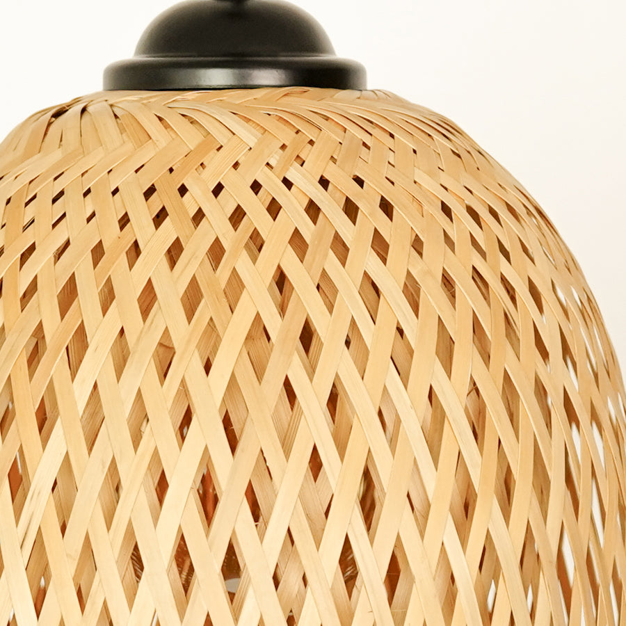 Closeup of handwoven rattan pendant light showcasing natural texture and artisan details.