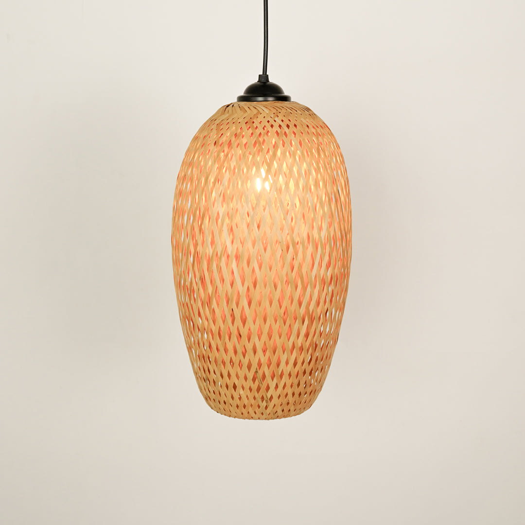 Handwoven rattan pendant light with natural finish illuminated for warm bohemian interiors.