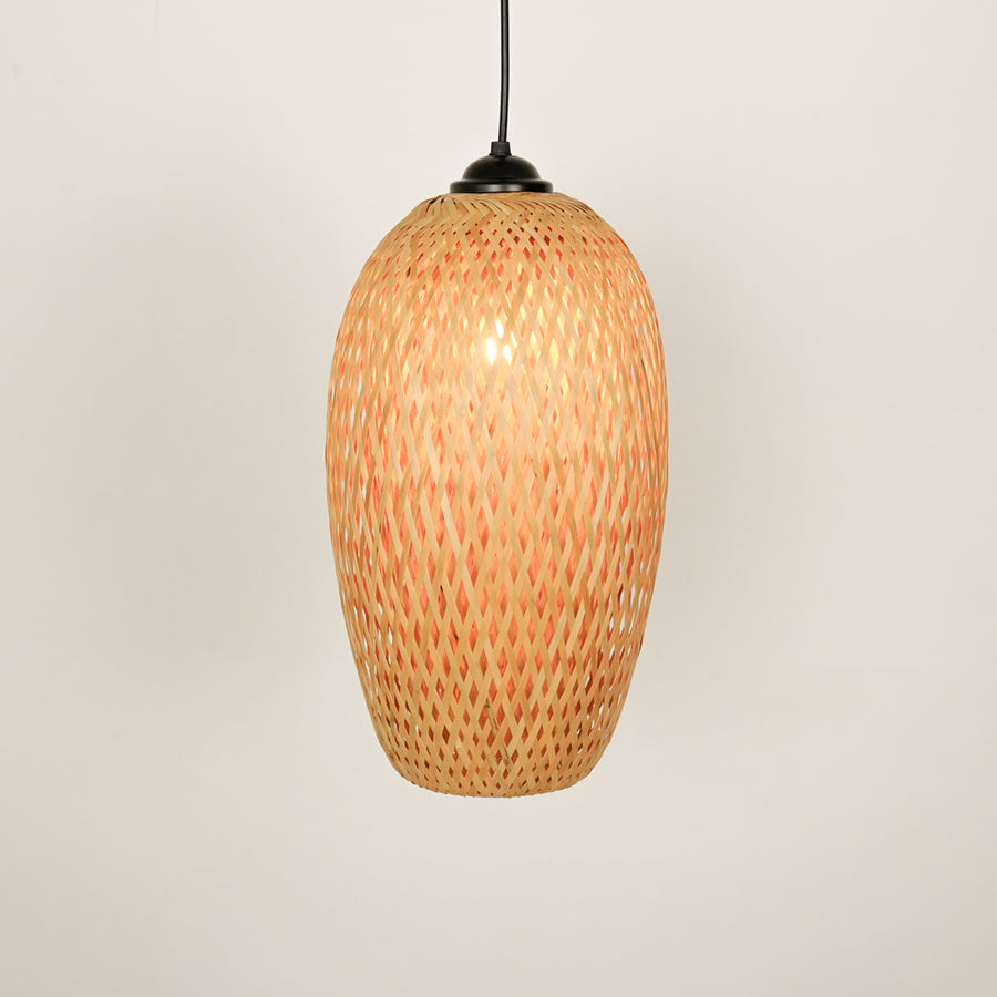 Handwoven rattan pendant light with natural finish illuminated for warm bohemian interiors.