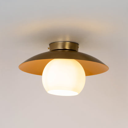 Modern gold metal ceiling light with frosted white glass globe for luxury living room and premium decor spaces.