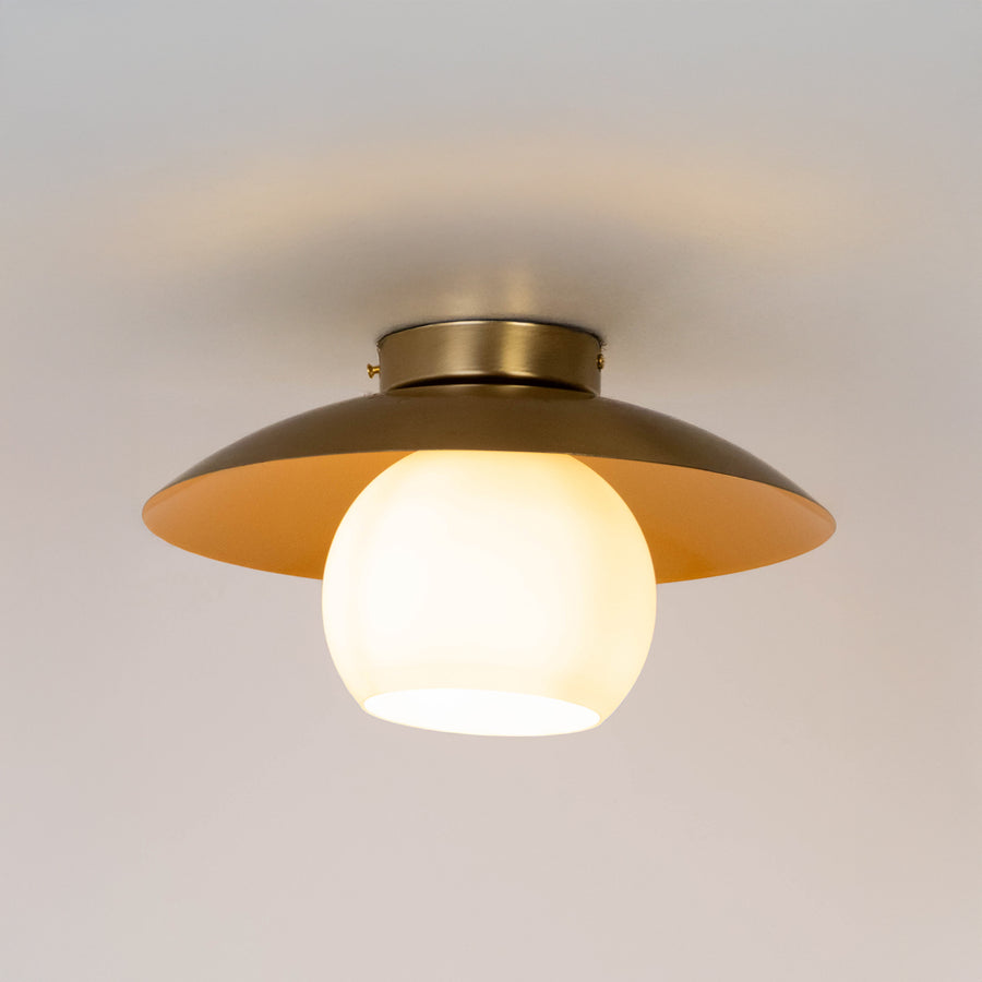 Modern gold metal ceiling light with frosted white glass globe for luxury living room and premium decor spaces.
