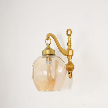 White background image of brass cast downward wall light for elegant modern living room decor styling and home lighting.