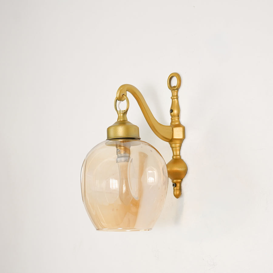 White background image of brass cast downward wall light for elegant modern living room decor styling and home lighting.