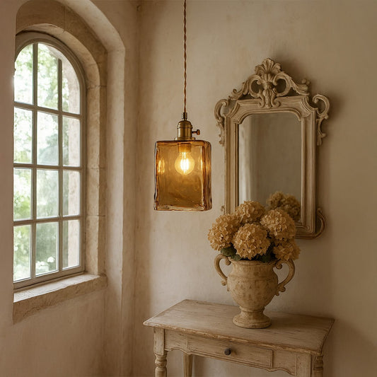 Amber marbled glass pendant light enhancing vanity decor with warm vintage elegance and charm.