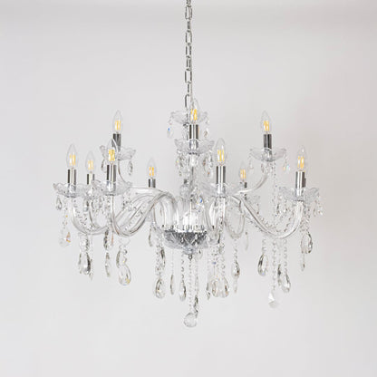 Crystal chandelier with glass arms candle lights and crystal drops turned off on white background decor.