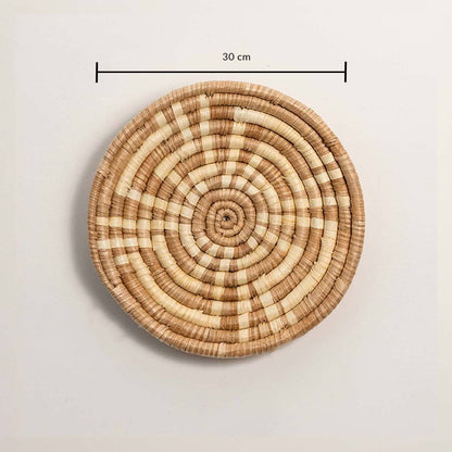 Dimension image of handcrafted natural brown cream seagrass wall basket with concentric spiral pattern for boho wall decor.