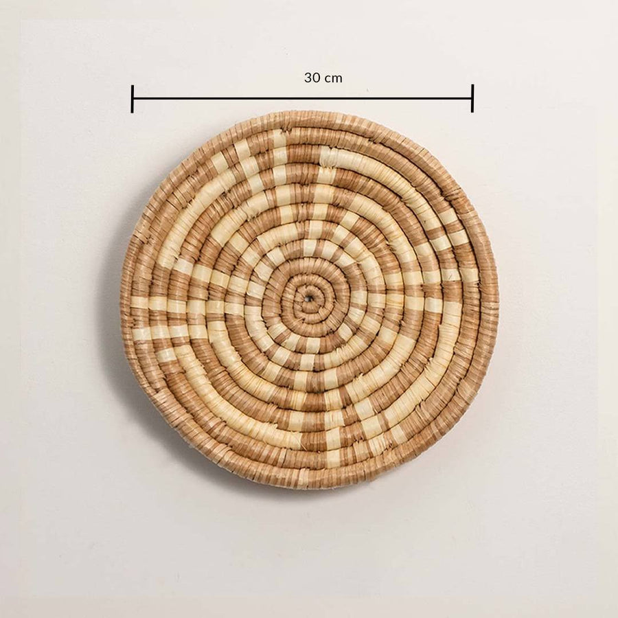 Dimension image of handcrafted natural brown cream seagrass wall basket with concentric spiral pattern for boho wall decor.