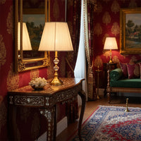 Classic table lamp with fabric shade and ornate metal base placed on antique console creating warm ambient glow in traditional living room.