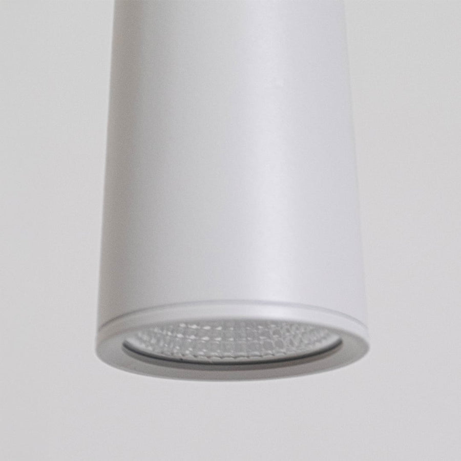 Detailed closeup of matte white metal pendant light showcasing the textured diffuser and premium minimalist design.