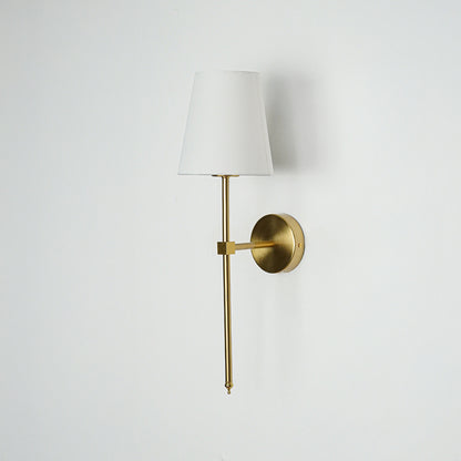 Minimal wall light in gold metal finish with fabric shade for bedroom or living room decor lighting white background.