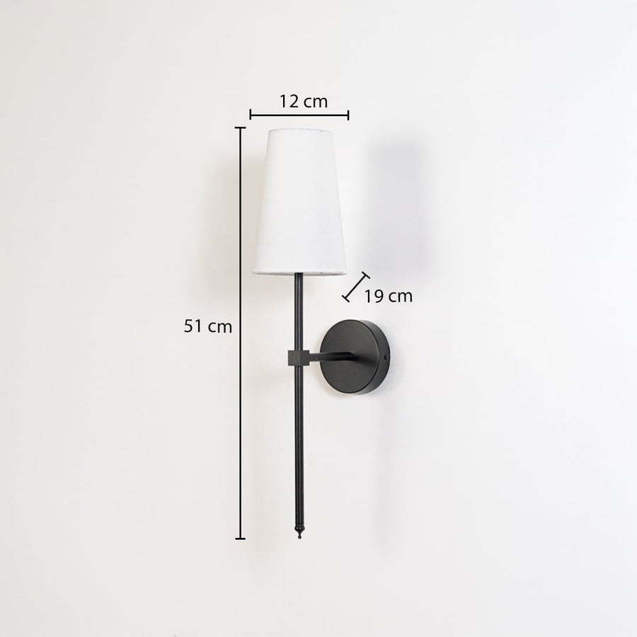 Modern white fabric drum wall sconce with black metal rod showing 51cm height 12cm shade width 19cm depth on white background.