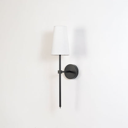 Contemporary white drum shade wall light fixture with tall black metal rod turned off on minimalist white background display.