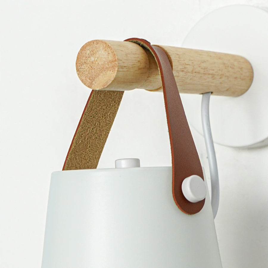 Modern white metal spotlight wall light with leather strap and wooden accents for stylish interiors.