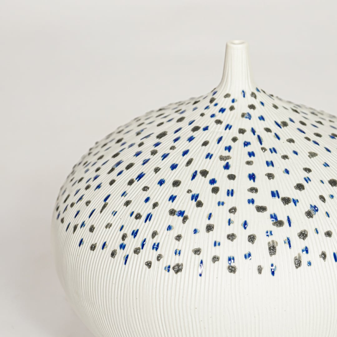 White ceramic decorative vase with detailed dotted blue and black pattern perfect for elegant dried floral display and interior decor.