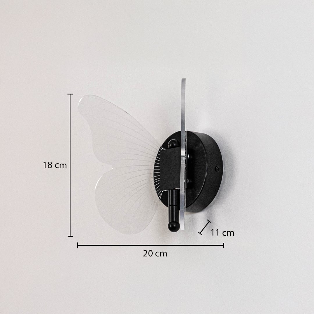Black butterfly wall light with clear acrylic wings shown with 18 cm height and 20 cm width for accurate sizing.