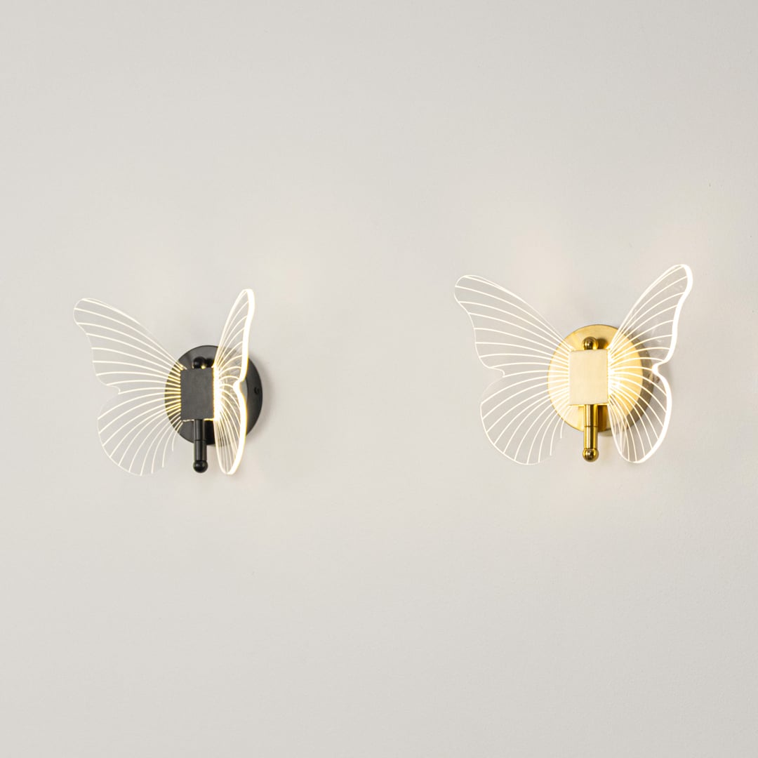 Butterfly themed wall lights with black base and clear acrylic wings illuminated on a clean white background.