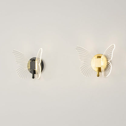 Butterfly themed wall lights with black base and clear acrylic wings illuminated on a clean white background.