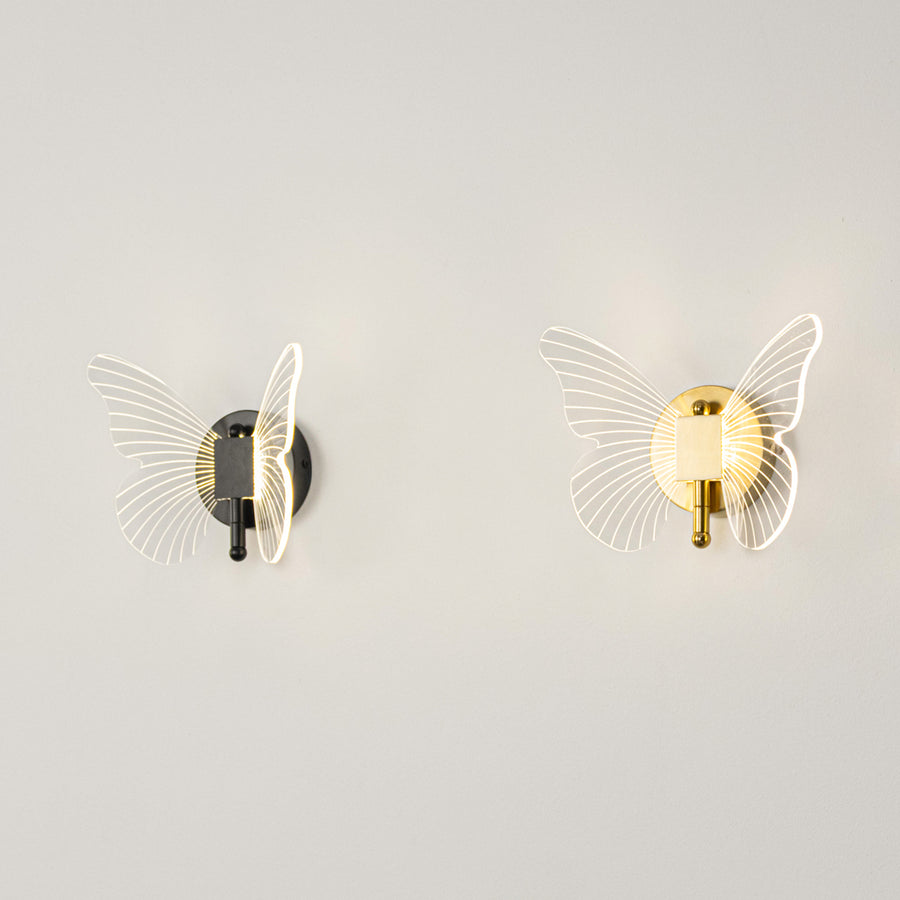 Modern wall light set in black and gold metal finish with textured glass design for bedroom or living decor lighting placement white background.