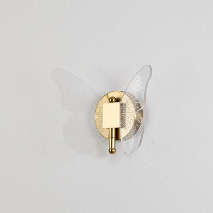 Gold butterfly design wall light with clear acrylic wings shown on a plain white background for accurate detailing.