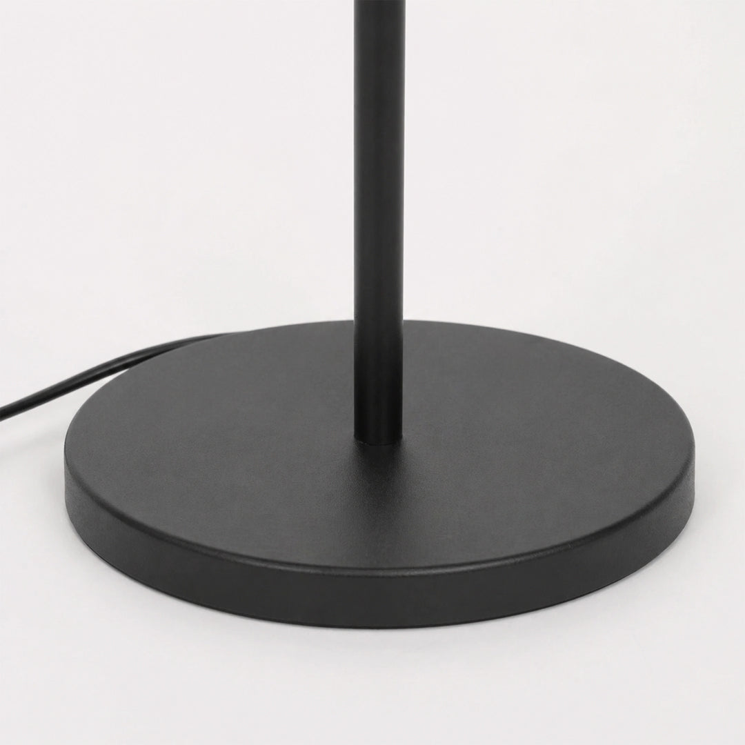 Closeup image of linear black metal floor lamp base for elegant living room decor styling and modern home lighting design.