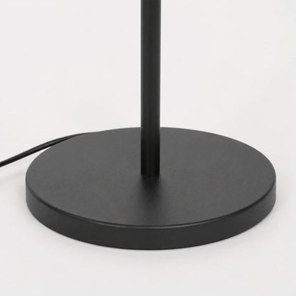 Closeup image of linear black metal floor lamp base for elegant living room decor styling and modern home lighting design.