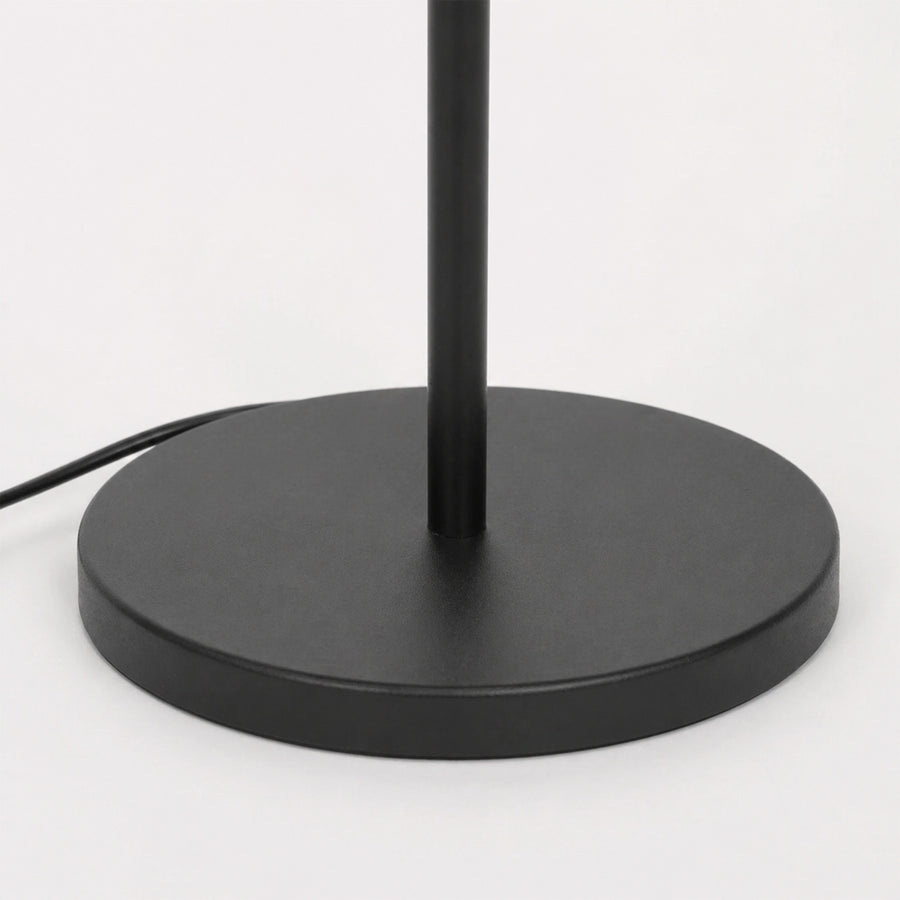 Closeup image of linear black metal floor lamp base for elegant living room decor styling and modern home lighting design.